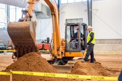 boy in excavator with engineer