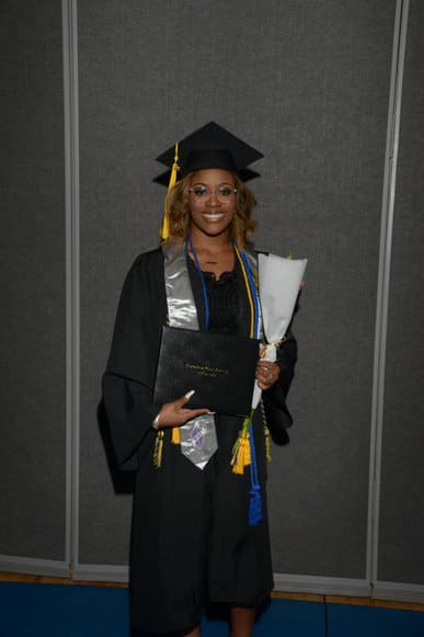 Graduate girl with diploma and flowers